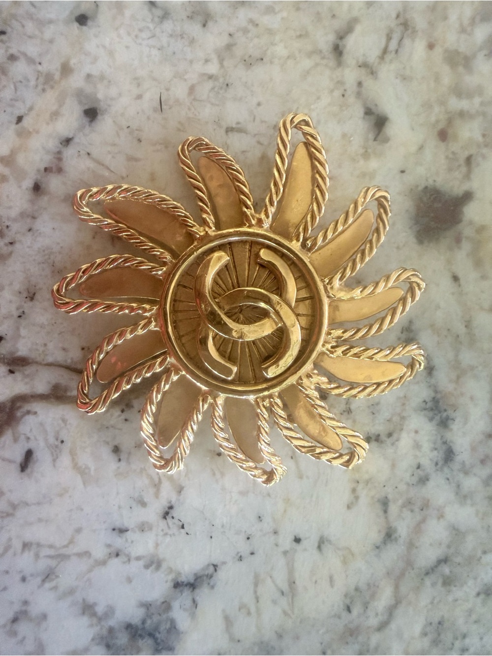 CHANEL Gold Sunburst Brooch with Interlocking CC